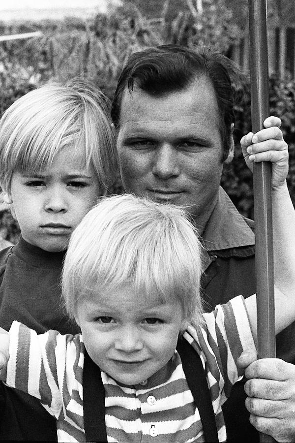 Barry Sadler and sons Thor and Baron on a swing Tucson Arizona 1971. Photograph by David Lee Guss