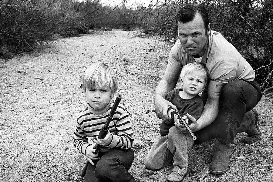 Barry Sadler instructing sons shooting with toy rifles Tucson Arizona 1971 Photograph by David Lee Guss