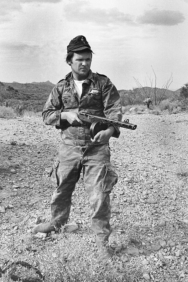 Barry Sadler shooting  a machine gun in the desert Tucson Arizona 1971 Photograph by David Lee Guss