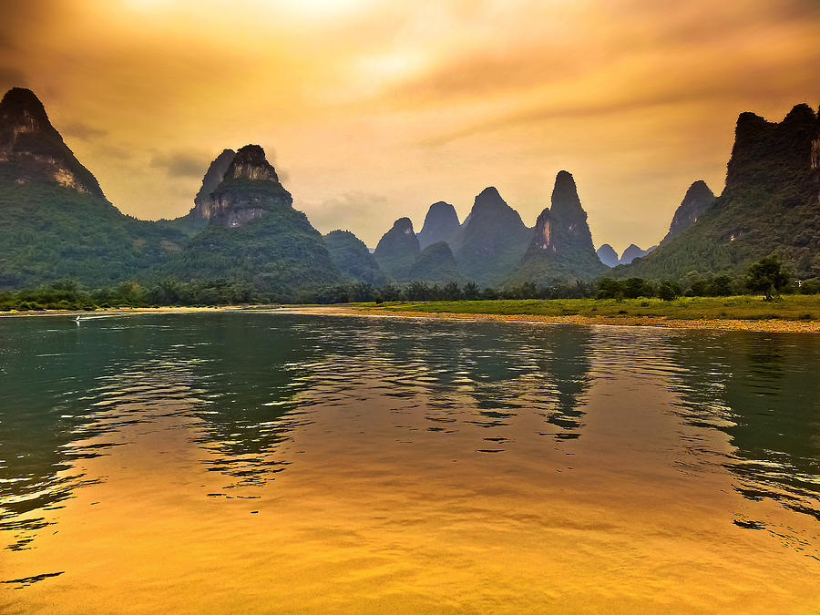Bathing in the golden landscape-China Guilin scenery Lijiang River in Yangshuo Photograph by Artto Pan