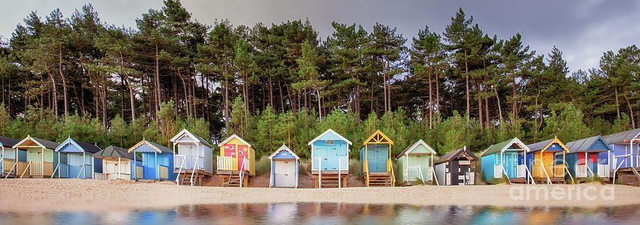 Beach hut row on the Norfolk coast Photograph by Simon Bratt