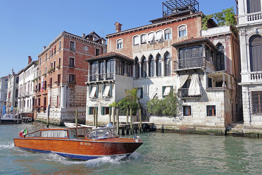 Who Or What Is Driving This Beautiful Boat Cruising The Canal In Venice, Italy Photograph by Rick Rosenshein