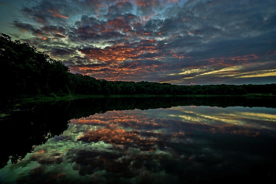 Beautiful painted sky reflected in lake water Photograph by Sven Brogren