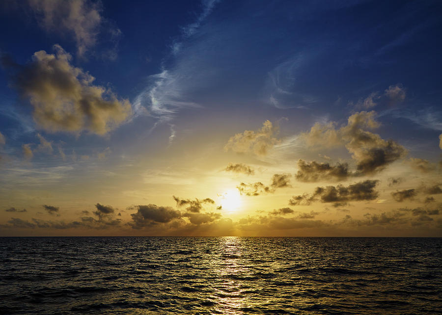 Beautiful sunset over sea with reflection in water, majestic clo ...