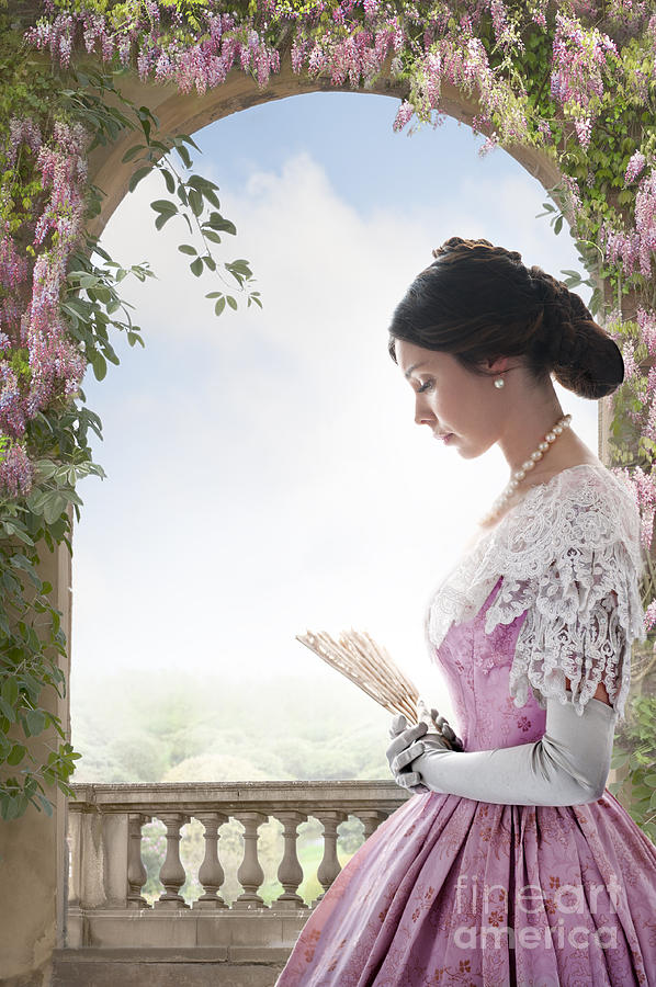 Beautiful Victorian Woman In Pink Dress Standing Under A Wisteri Photograph by Lee Avison