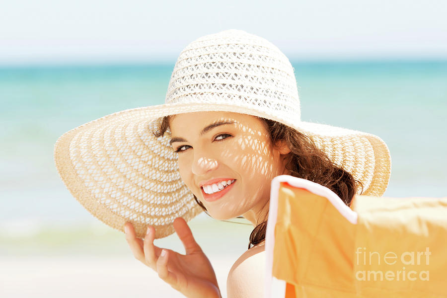 Beautiful Young Woman In A Hat And Swimsuit Over Seaside Backgro