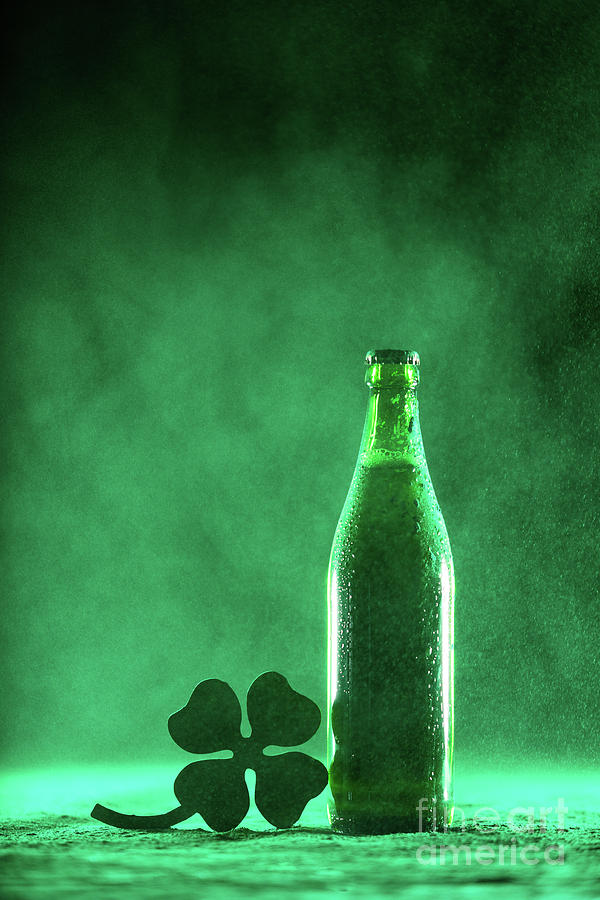 Beer Photograph - Beer bottle and a shamrock on a dusty background by Michal Bednarek