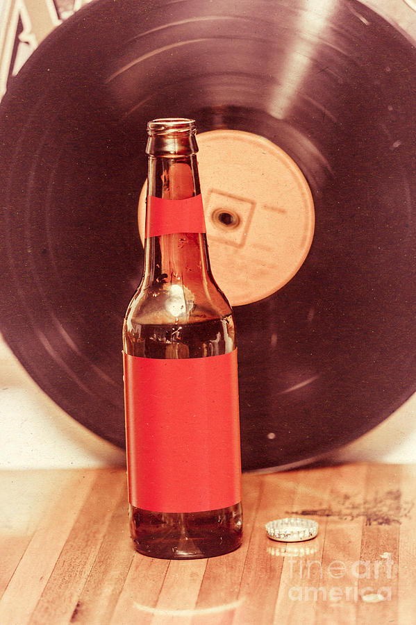 Beer bottle on bar counter top with vinyl record Photograph by Jorgo Photography