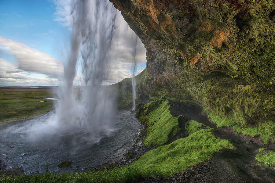 Behind waterfall in Iceland Photograph by Dave Dilli