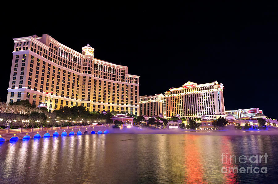Bellagio and Caesars at Night Photograph by John Rizzuto