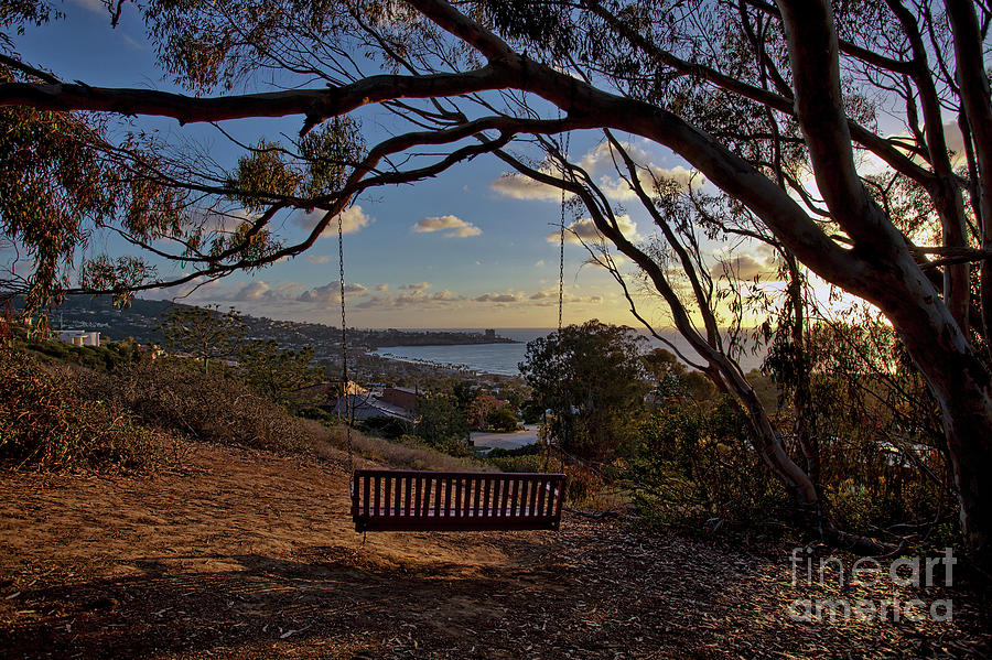 Bench swing overlooking the ocean at sunset Photograph by Sam Antonio