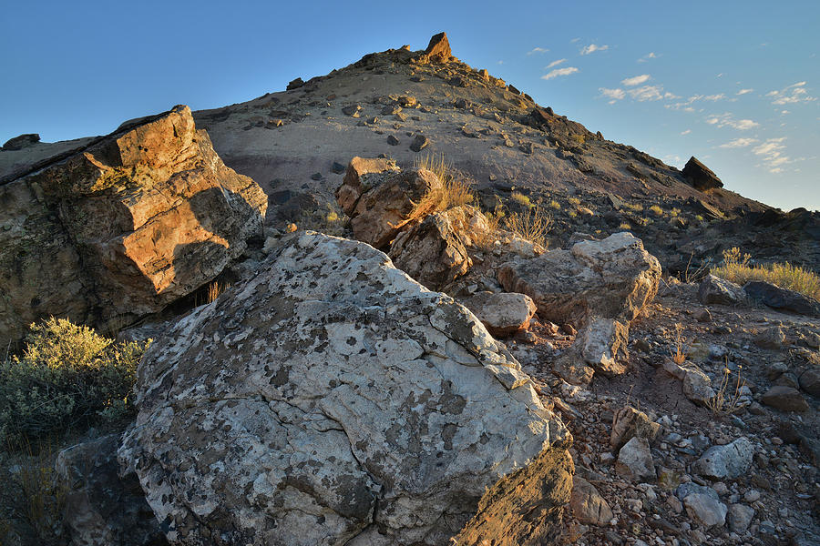 Bentonite Hills and Boulders Light at Sunrise Photograph by Ray Mathis