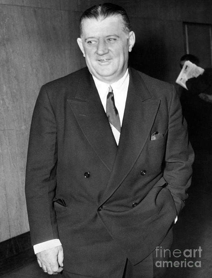 Bert Bell, commissioner of the NFL, holds football near photo mural of  Yankee Stadium in the New York Yankees' downtown office, Jan. 27, 1956. The New  York Giants of the NFL announced