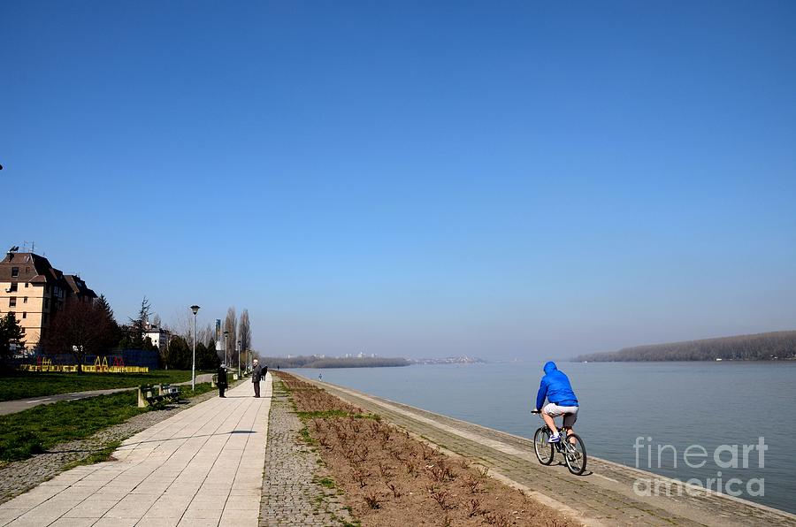 Bicyclist and senior couple at bank of Sava River Belgrade Serbia Photograph by Imran Ahmed