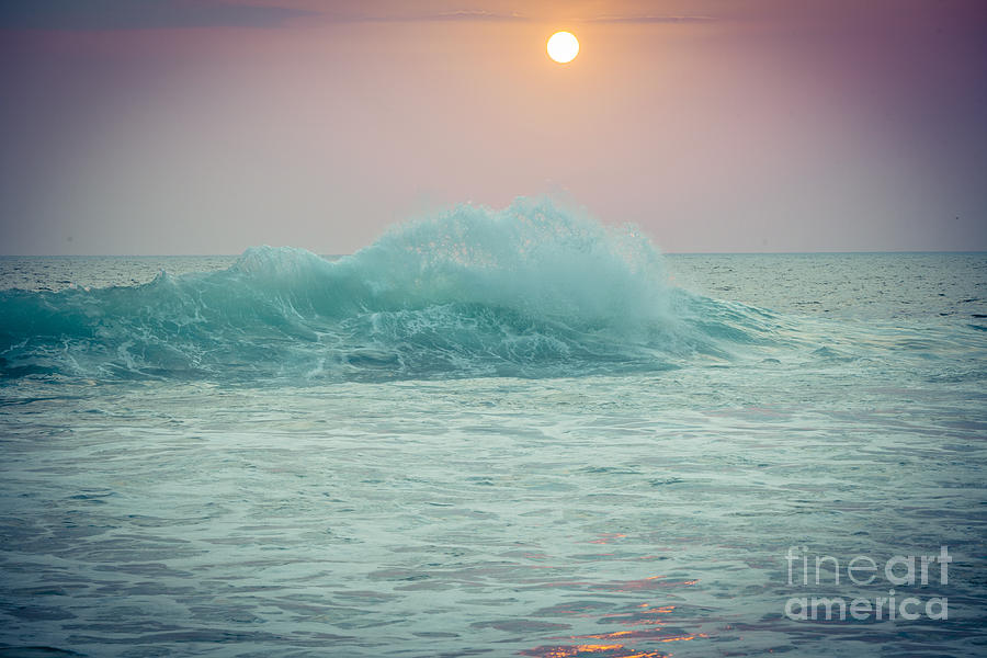 Big ocean wave at sunset with sun Photograph by Raimond Klavins