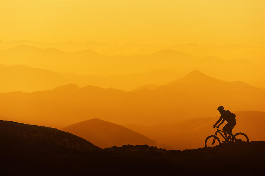 Biker Riding On Mountain Silhouettes Background Photograph by Mikel Martinez de Osaba