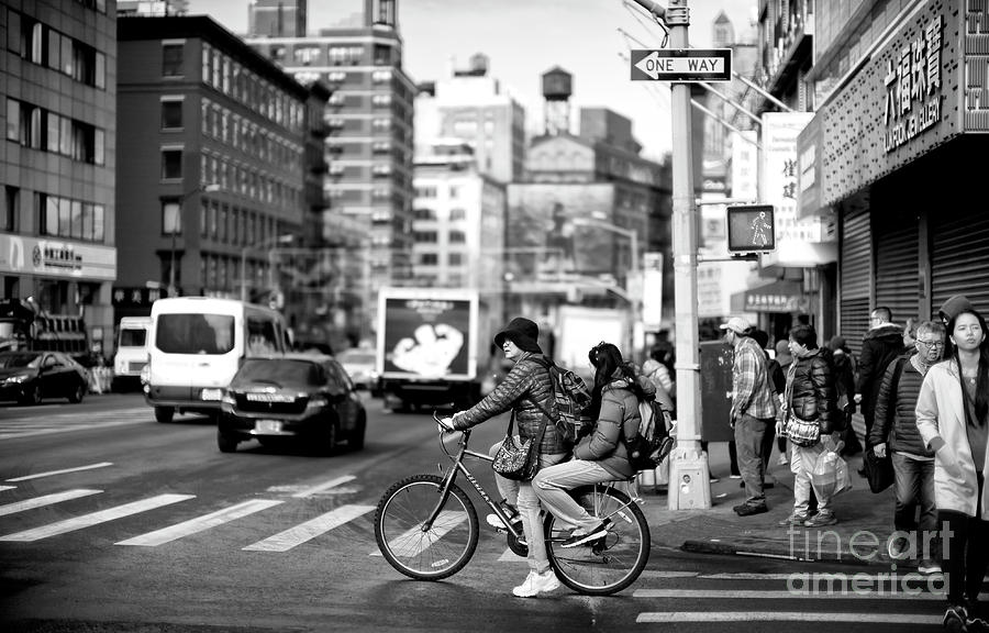 Biking on Canal Street in New York City Photograph by John Rizzuto