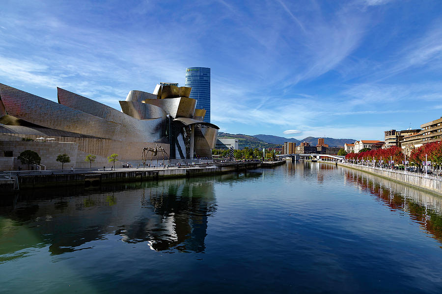 Bilbao in autumn with blue skies next to the river Nervion Photograph by Andy Myatt