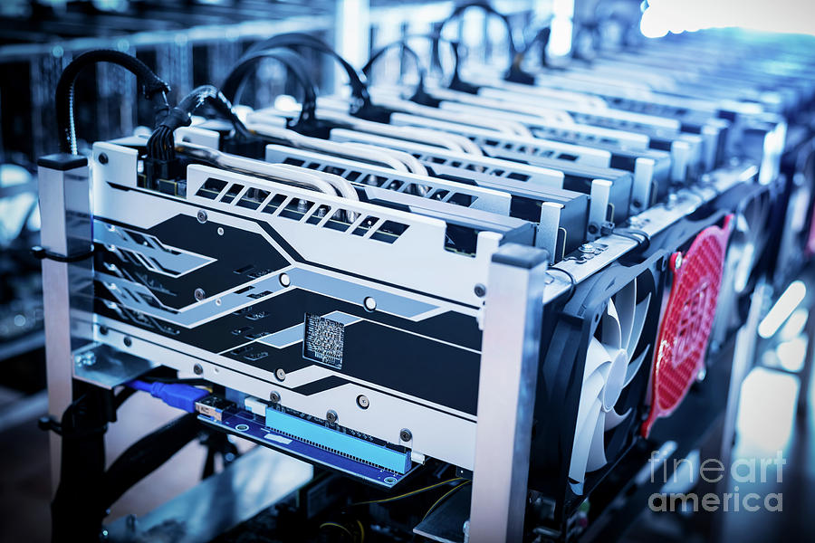 Bitcoin mining devices standing in a row. Photograph by Michal Bednarek