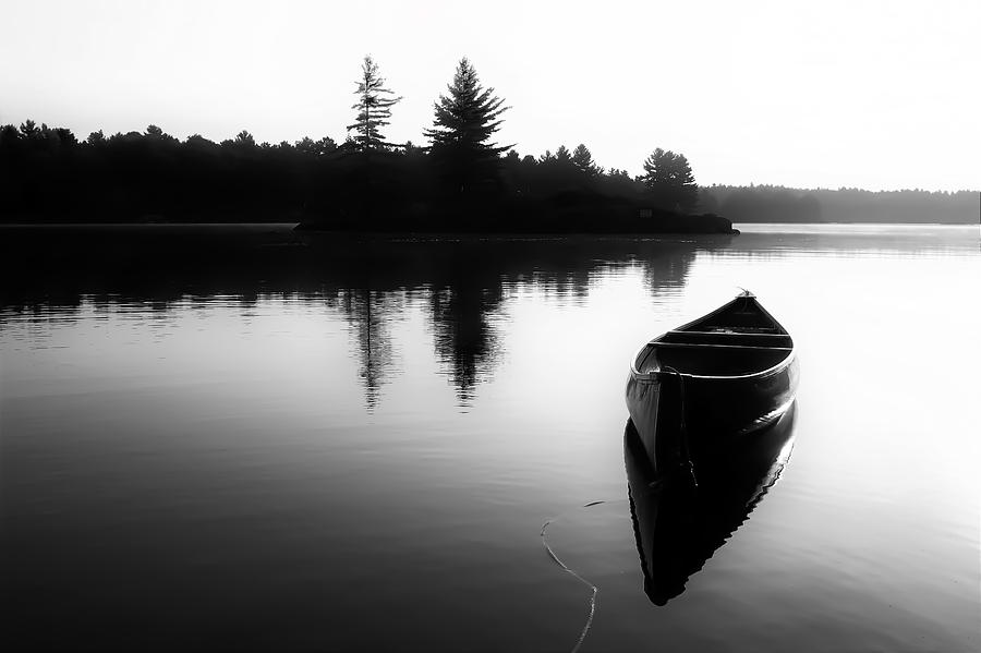 Cottage Photograph - Black And White Canoe In Still Water by Karl Anderson