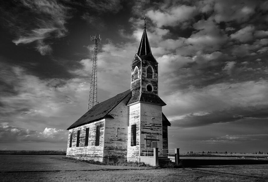 Black and white of an old church in front of a radio tower   Photograph by Jeff Swan