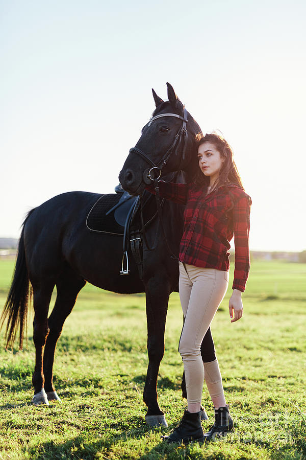 Black horse and an attractive young woman Photograph by Michal Bednarek