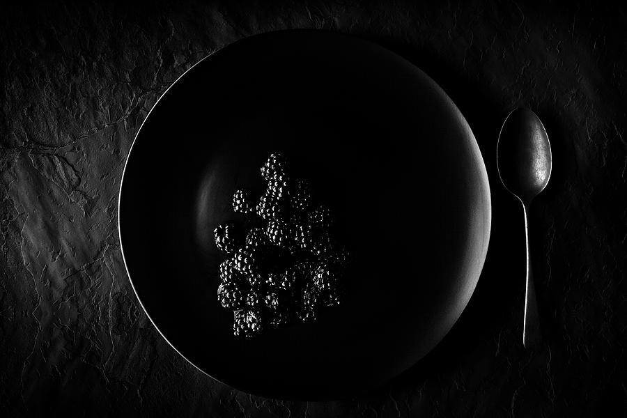 Blackberries on black plate  Photograph by Johan Swanepoel