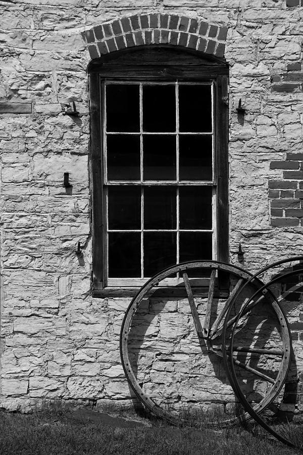 Blacksmith Shop Window w Wheel BW Photograph by Mary Bedy