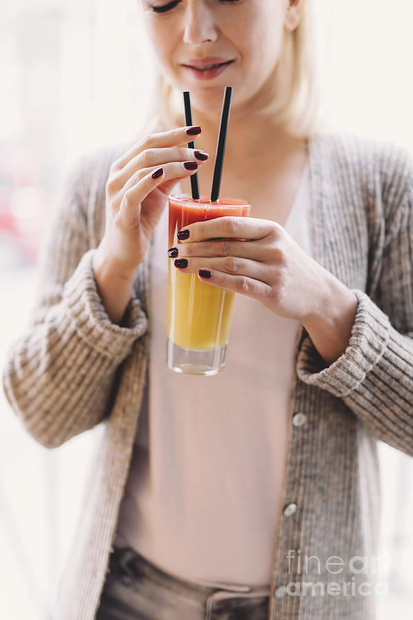 Blonde woman holding a colorful drink Photograph by Michal Bednarek