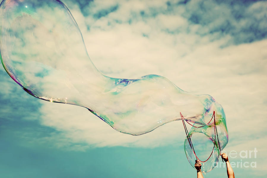 Blowing big soap bubbles in the air Photograph by Michal Bednarek
