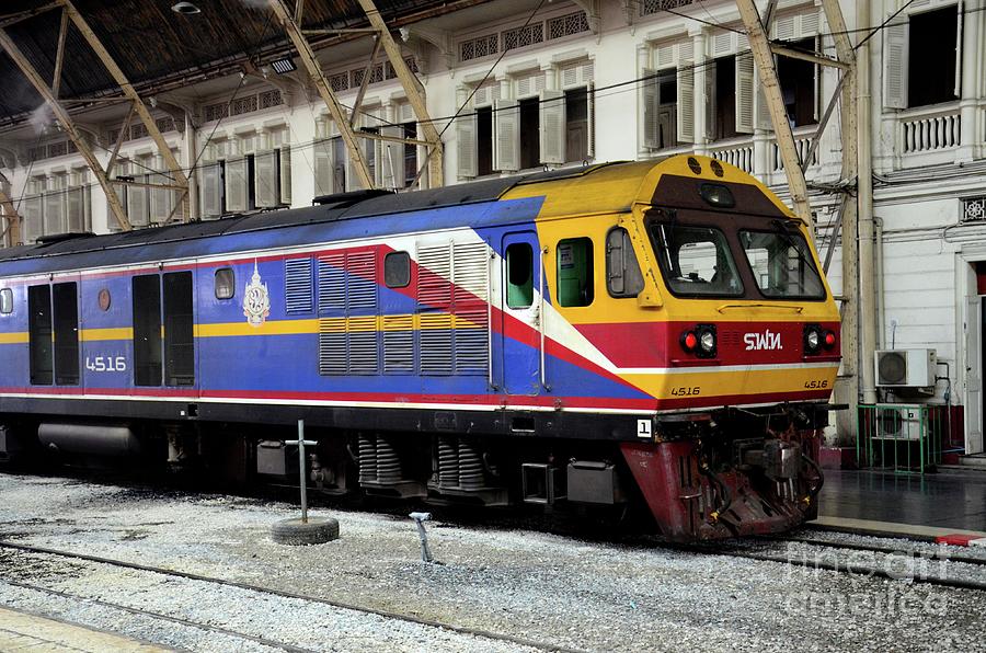 Blue and yellow Thai railways diesel electric locomotive parked at Bangkok train station Thailand Photograph by Imran Ahmed