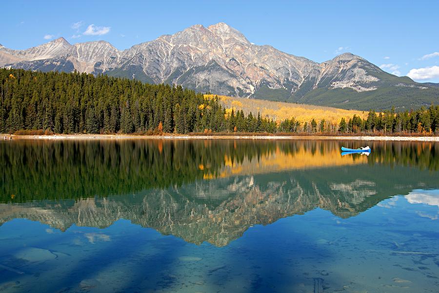 Blue Canoe on Patricia Lake Photograph by Larry Ricker