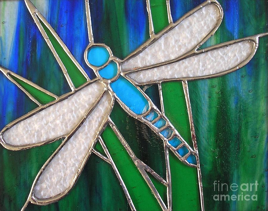 Blue dragonfly on reeds with bluey green background Glass Art by Karen Jane Jones