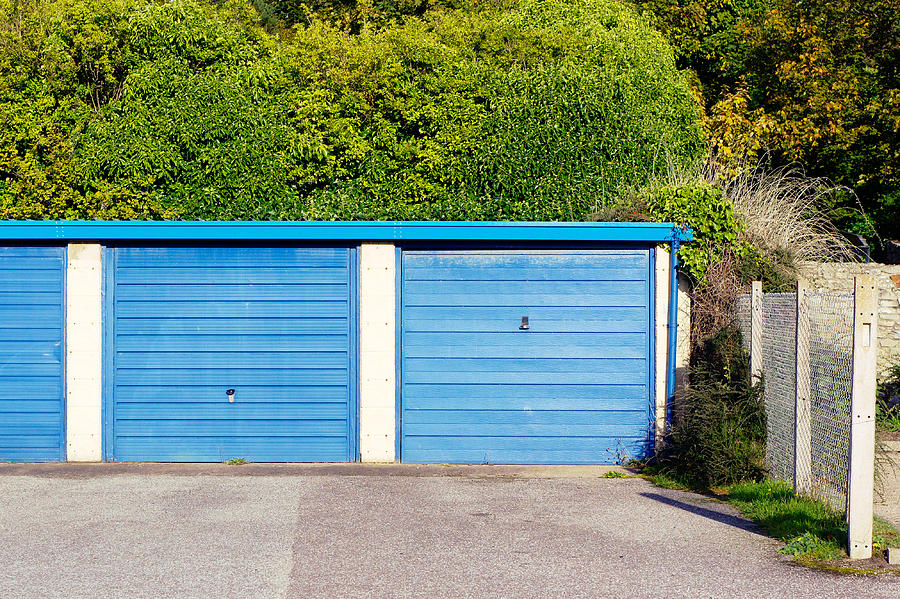 Brick Photograph - Blue garage doors by Tom Gowanlock