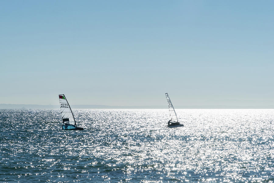 Blue Ocean Sports - Two Windsurfers on Shimmering Seas Photograph by Georgia Mizuleva