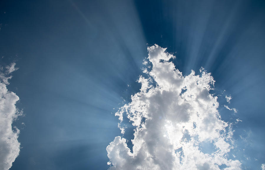 Blue sky with white clouds and  sun rays Photograph by Michalakis Ppalis