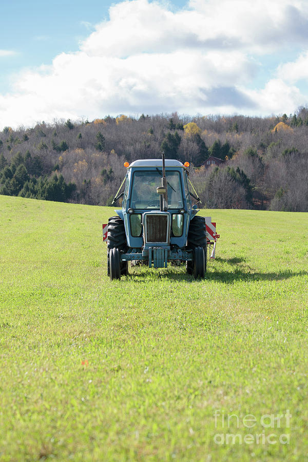 Blue vintage tractor in a pasture Photograph by Edward Fielding