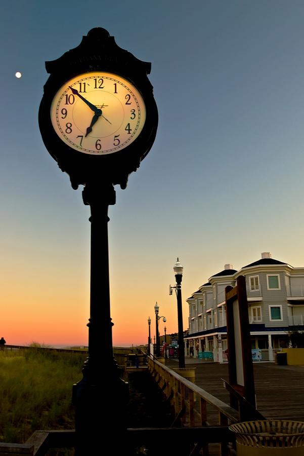 Boardwalk clock with rising moon. Bethany Beach. Photograph by Bill Jonscher