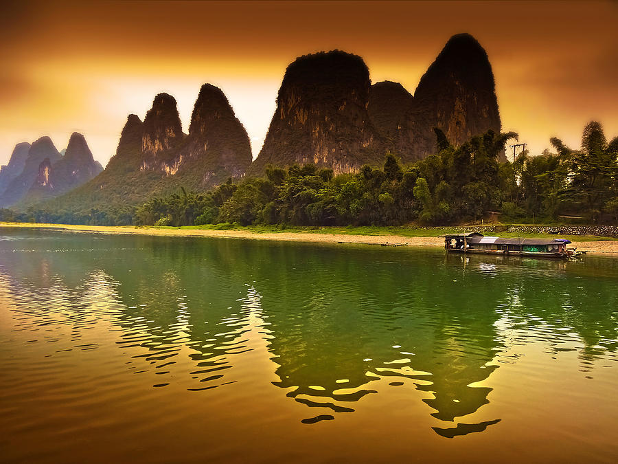 Boat Breaks Tranquil Evening Reflection-China Guilin scenery Lijiang River in Yangshuo Photograph by Artto Pan