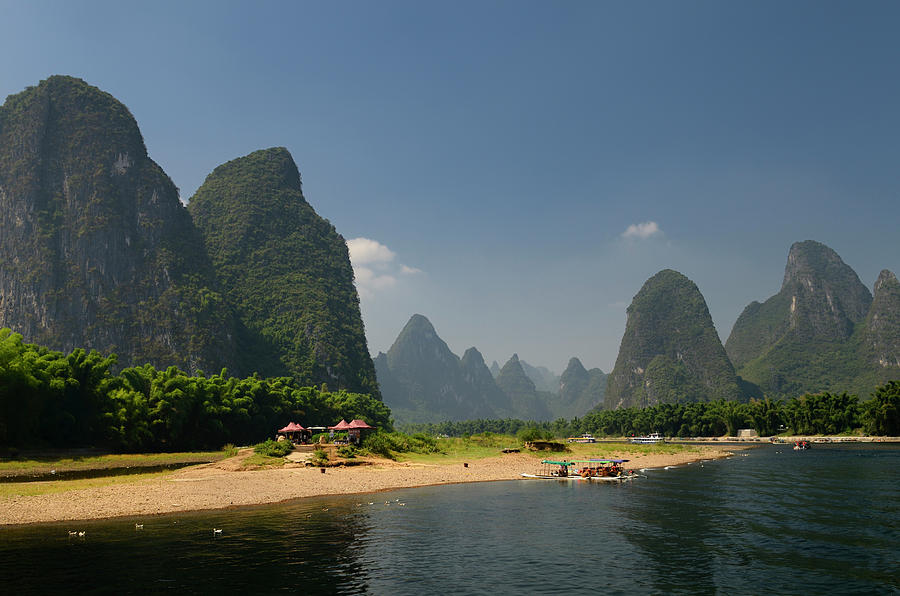 Boats and rest stop on the Li river China with tall karst format Photograph by Reimar Gaertner