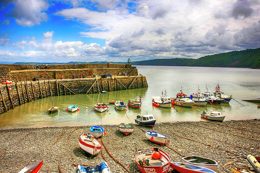 Boats in the harbor at Clovelly in Devon Photograph by Chris Smith