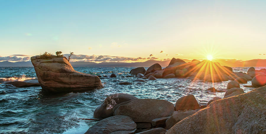 Bonsai Rock Lake Tahoe Summer Sunset with Waves Crashing and Hazy Light Blue Sky and Strong Sun Rays Photograph by Brian Ball