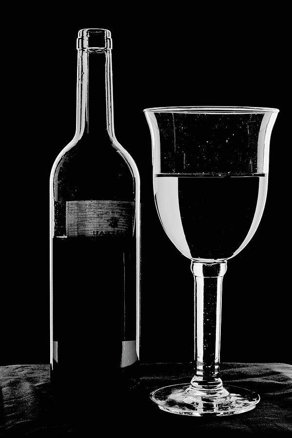 Bottle and Glass - high key monochrome. Photograph by John Paul Cullen