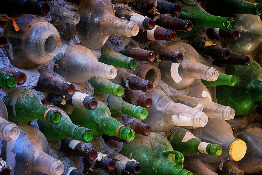 Bottles And Cement Wall Photograph by Tom Singleton