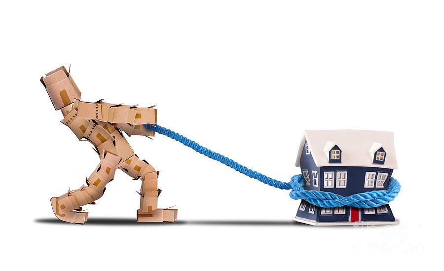 Rope Photograph - Box character pulling a house with a rope by Simon Bratt