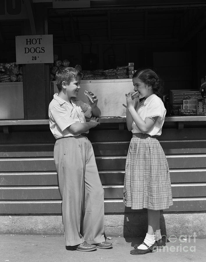 Boy And Girl Eating Hot Dogs, C.1950s Photograph by H. Armstrong Roberts/ClassicStock