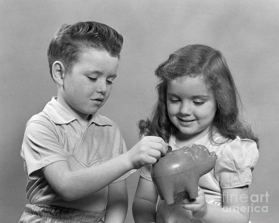 Boy And Girl Putting Money Into Piggy Photograph by H. Armstrong Roberts/ClassicStock