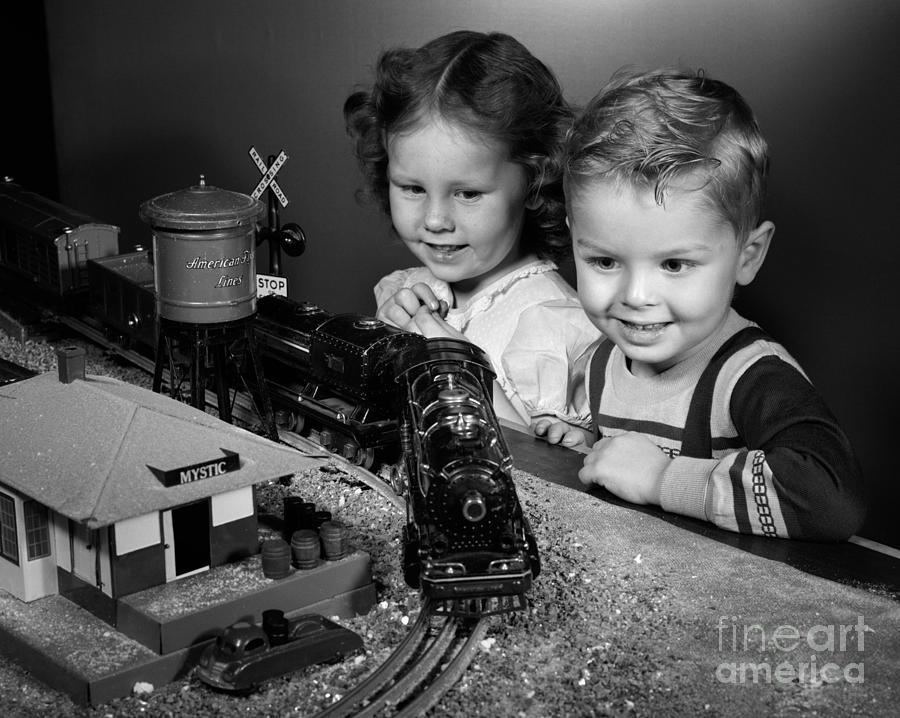 Boy And Girl With Train Set, C.1950s Photograph by H. Armstrong Roberts/ClassicStock