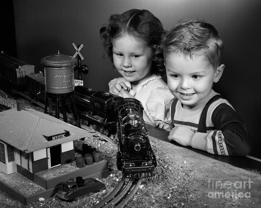 Boy And Girl With Train Set, C.1950s by H. Armstrong Roberts/ClassicStock