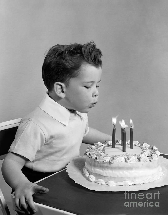 Boy Blowing Out Candles On Cake, C.1950s Photograph by H. Armstrong Roberts/ClassicStock